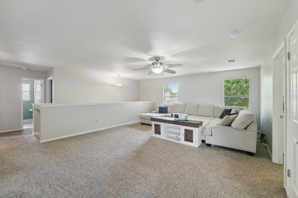 504 Chaparral Drive Leander, TX 78641 - Photo 17 of 34 a living room with furniture and a chandelier
