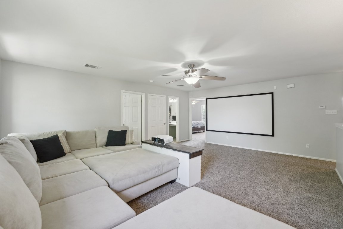 504 Chaparral Drive Leander, TX 78641 - Photo 18 of 34 a bedroom with a bed and lamp