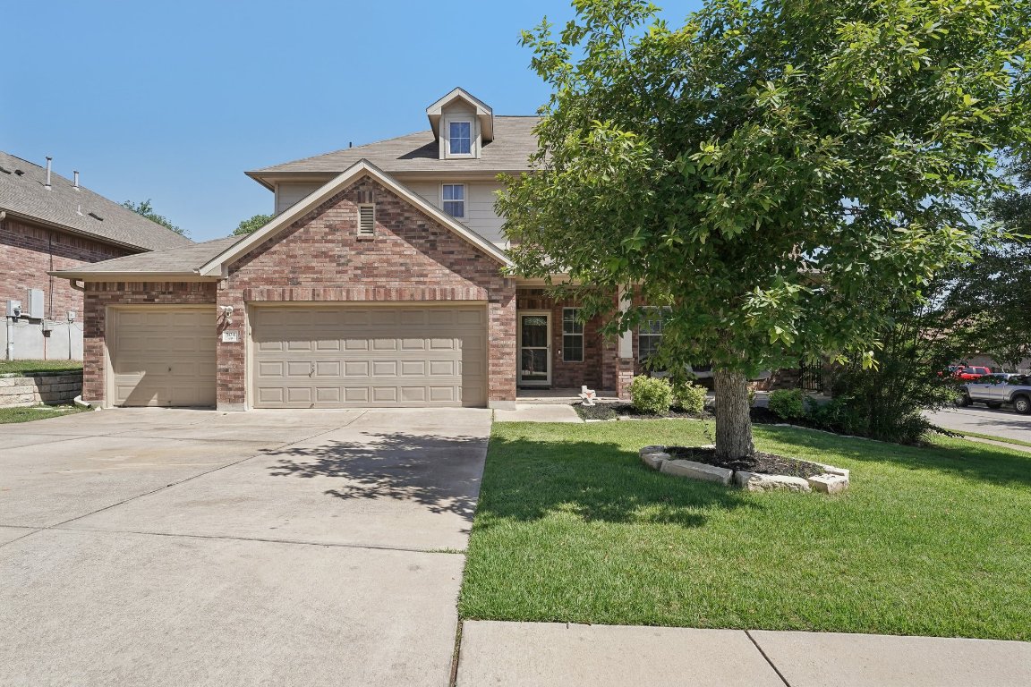504 Chaparral Drive Leander, TX 78641 - Photo 2 of 34 a front view of a house with a garden