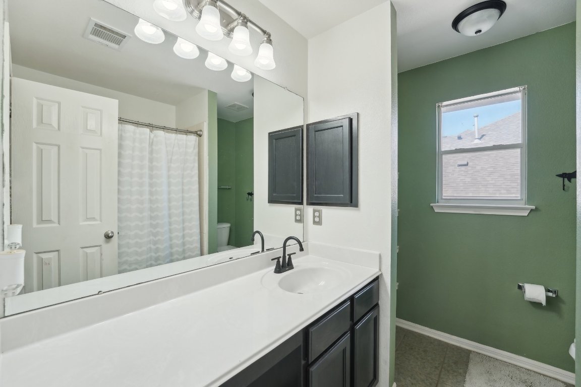 504 Chaparral Drive Leander, TX 78641 - Photo 23 of 34 a bathroom with a sink and a mirror