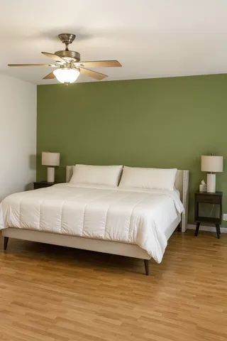 a bedroom with a bed and a chandelier