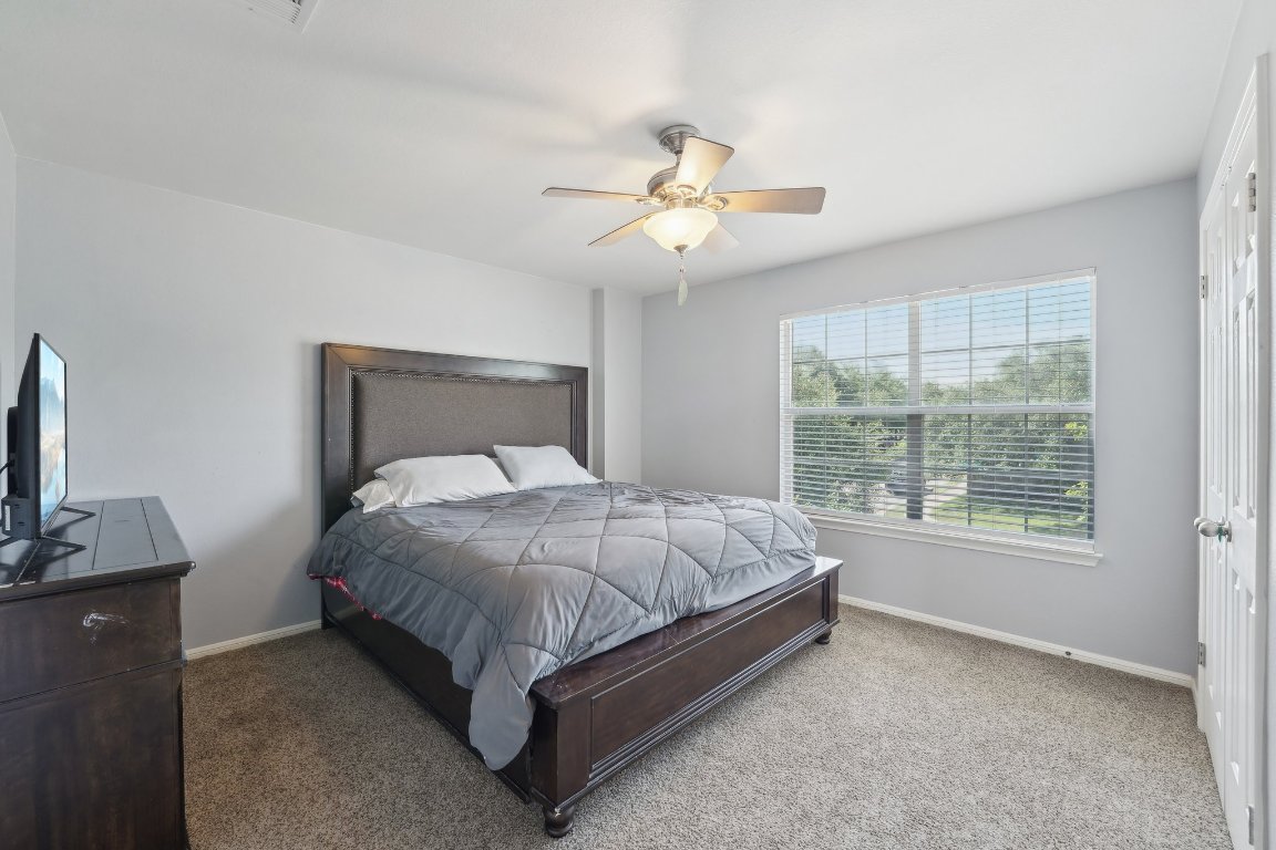 504 Chaparral Drive Leander, TX 78641 - Photo 28 of 34 a bed sitting in a bedroom next to a window
