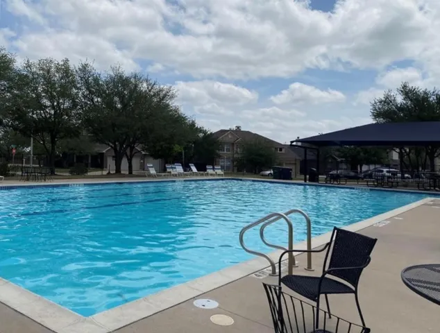 a view of a backyard with sitting area