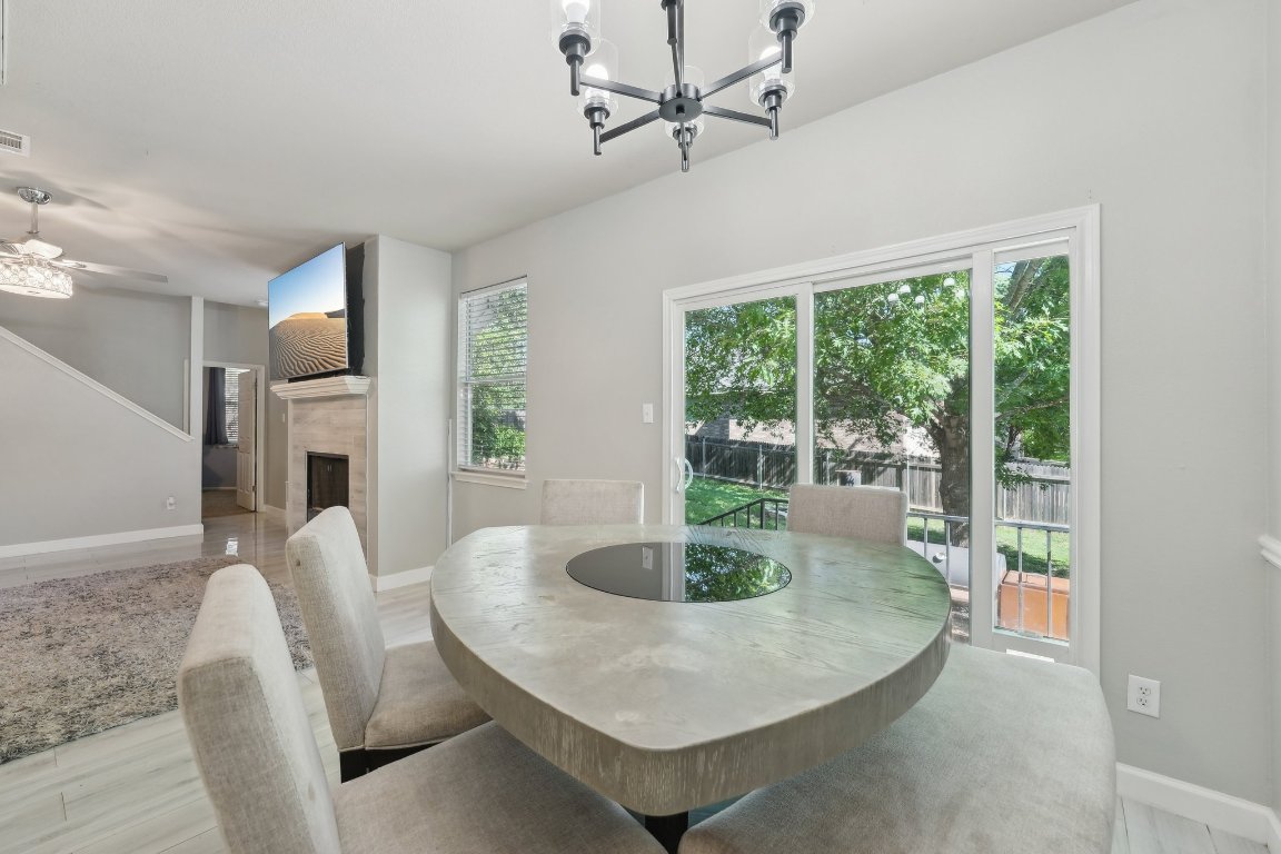 504 Chaparral Drive Leander, TX 78641 - Photo 7 of 34 a dining room with furniture and a floor to ceiling window