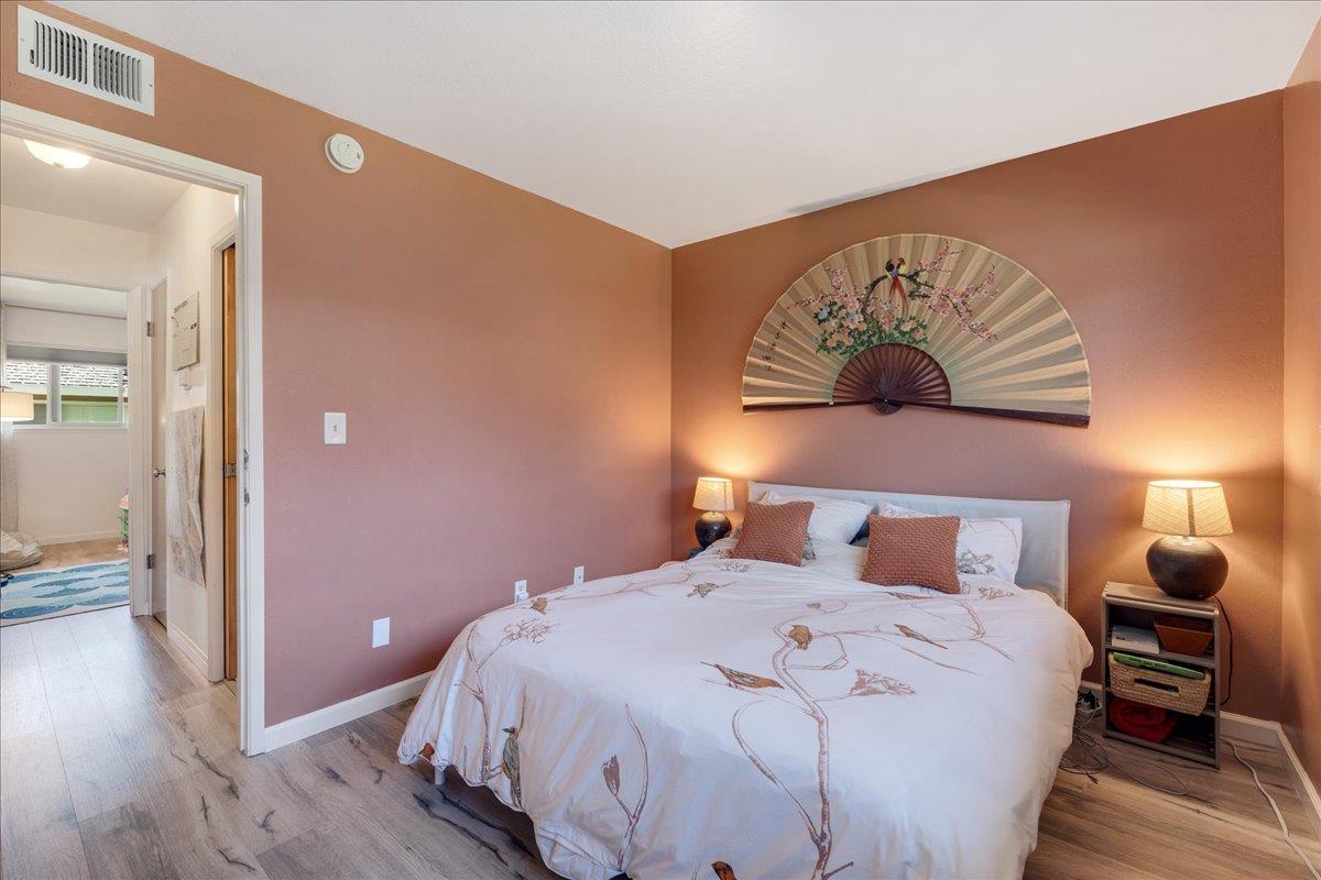 1415 Ruby Court, Unit 1 Capitola, CA 95010 - Photo 8 of 20 a bedroom with a bed and wooden floor