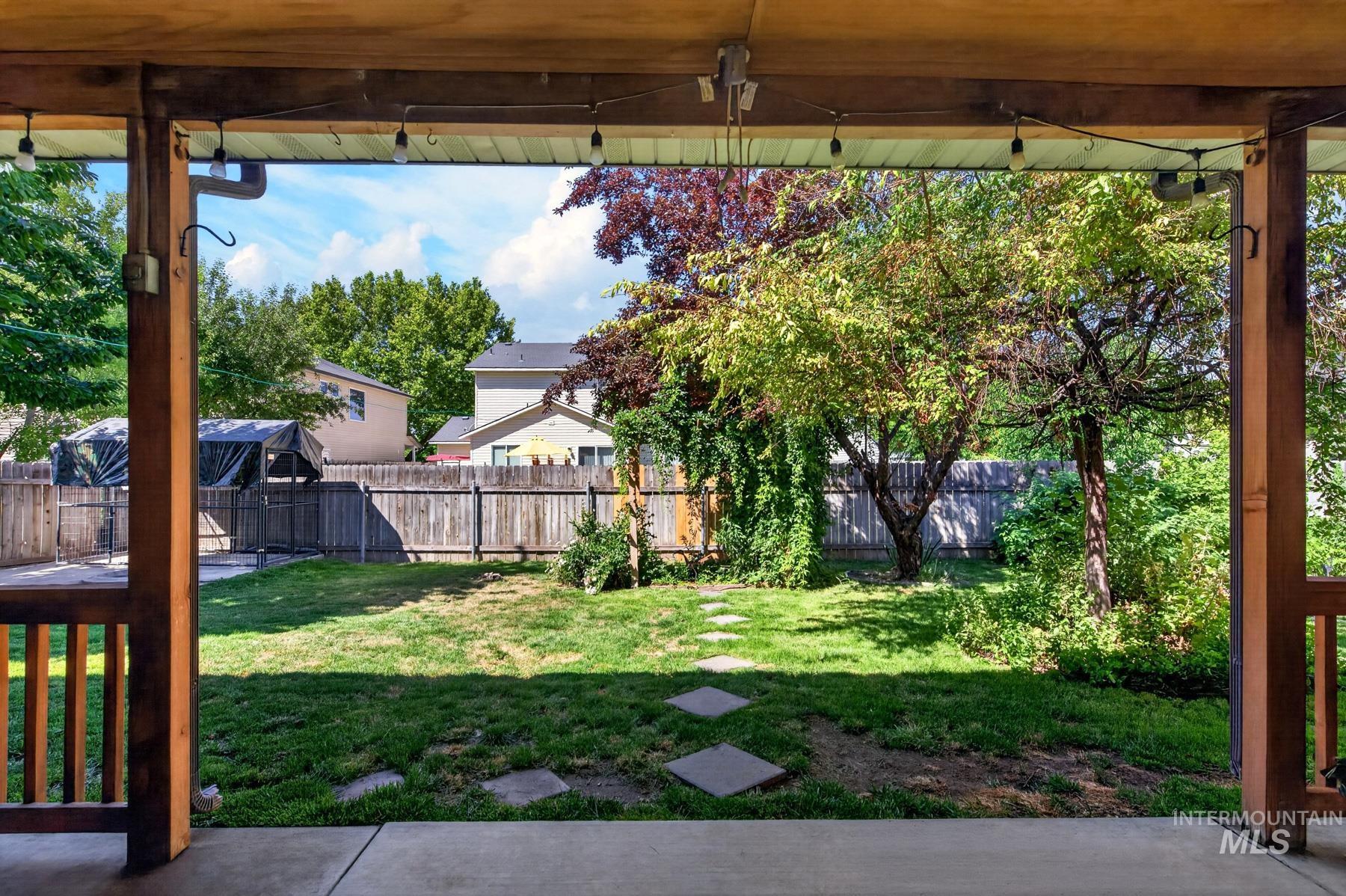 5020 Northrup Way Caldwell, ID 83607 - Photo 29 of 36 Covered patio with exposed wooden beams and string lighting