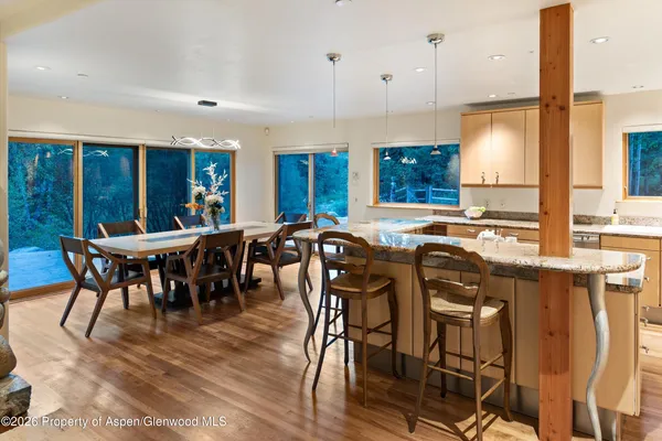 a kitchen with a stove and a wooden floor