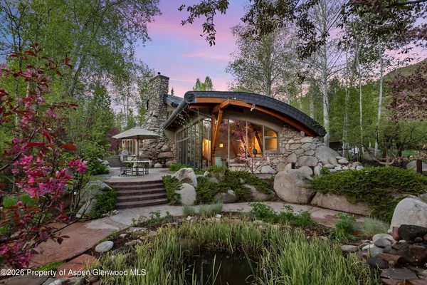 a view of a table and chairs under an umbrella