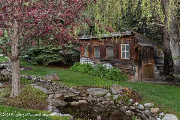 a view of backyard with outdoor seating and green space