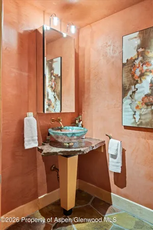 a bedroom with double bed and a flat tv screen on dresser