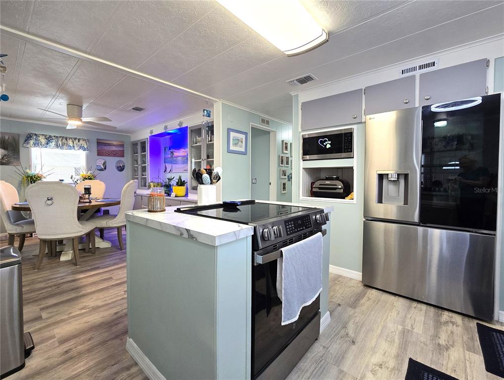 5619 Bayshore Road, Unit 435 Palmetto, FL 34221 - Photo 3 of 56 a kitchen with stainless steel appliances granite countertop a stove and a refrigerator