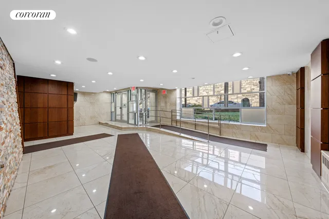 a view of a kitchen with kitchen island granite countertop a large window
