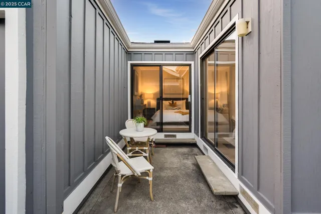 a view of a hallway with wooden floor and a living room