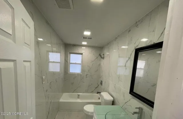 a bathroom with a bathtub and a shower