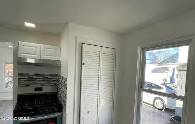 a kitchen with a refrigerator and a stove top oven