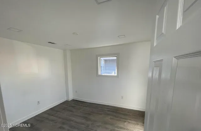 an empty room with wooden floor