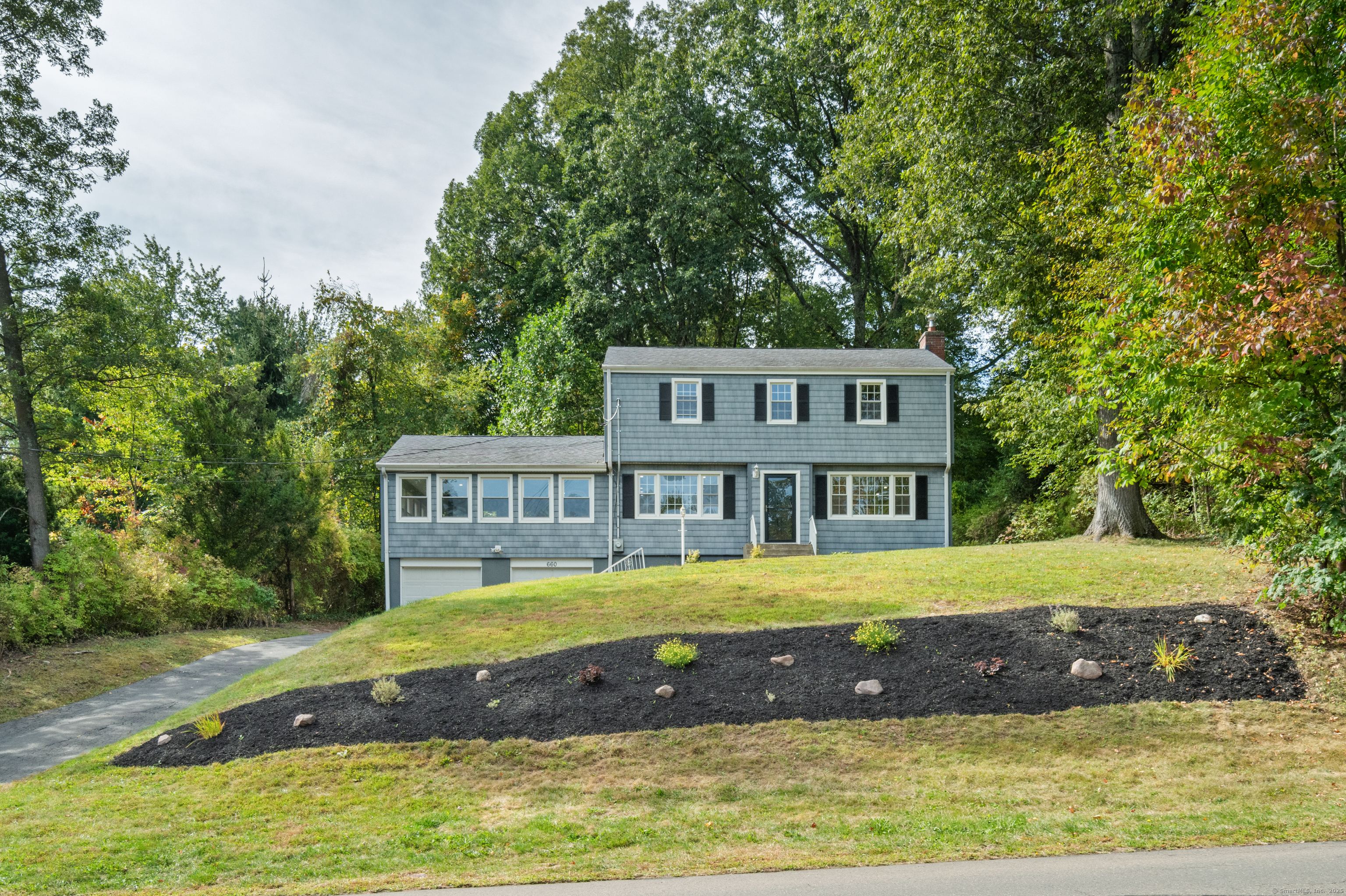 a view of a house with a garden and swimming pool