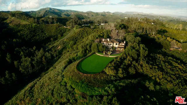 a view of a garden with an outdoor seating