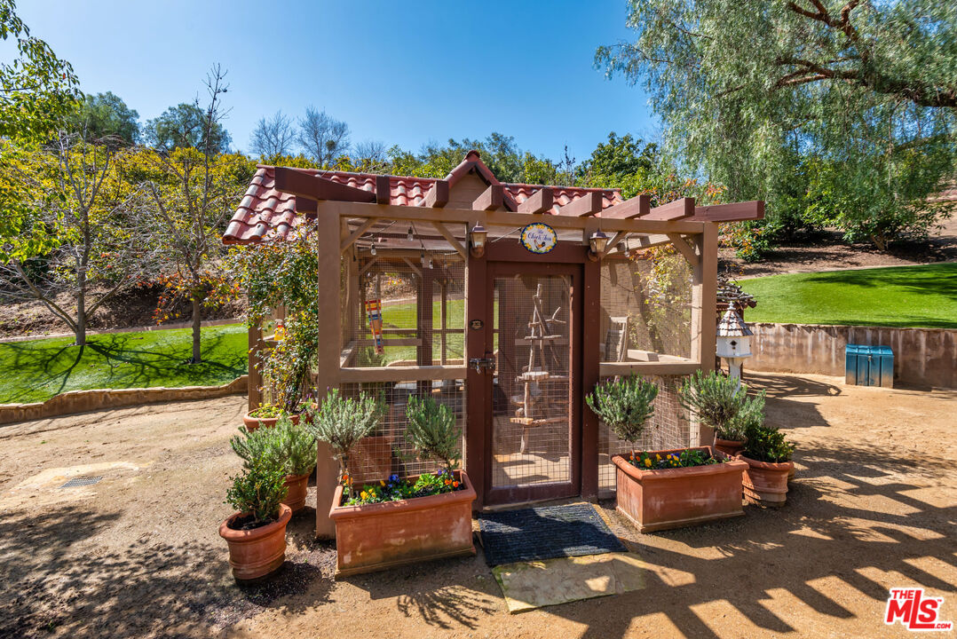 8018 Balcom Canyon Road Somis, CA 93066 - Photo 27 of 36 a view of a house with a flower garden