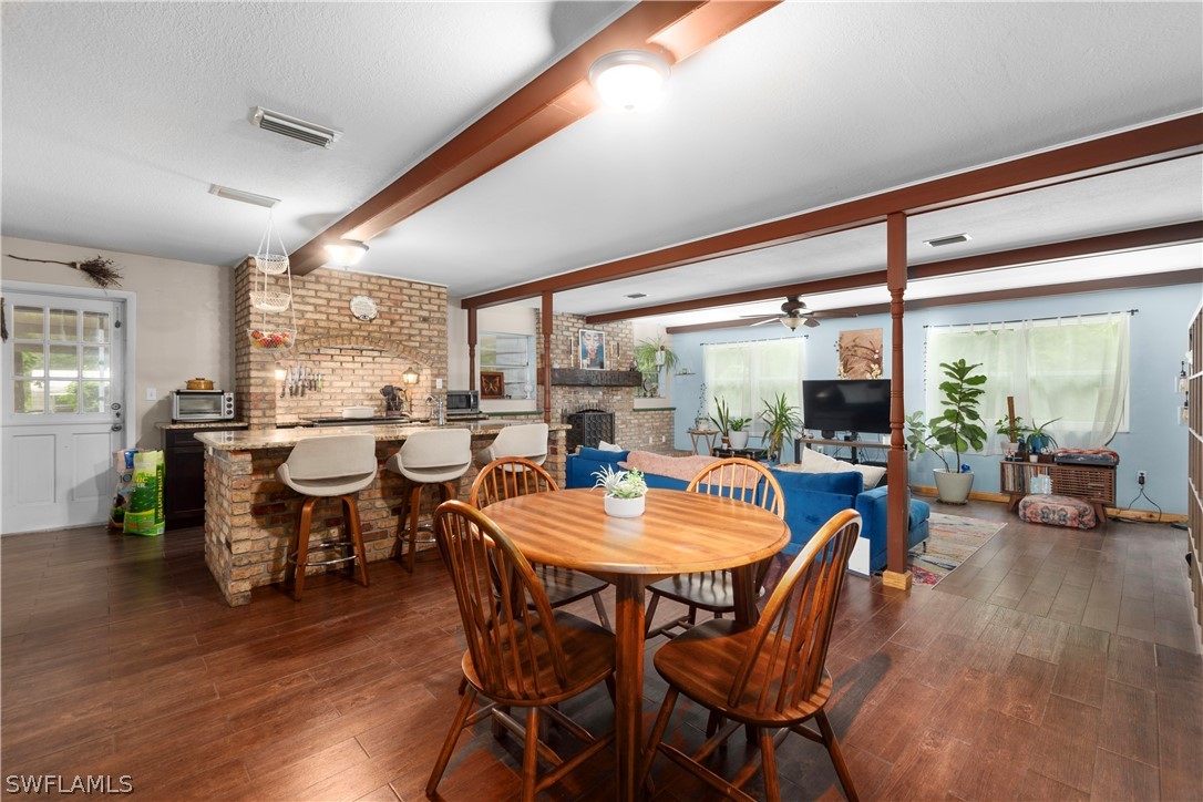 1745 County Road 731 Venus, FL 33960 - Photo 12 of 45 a dining room with furniture window and wooden floor