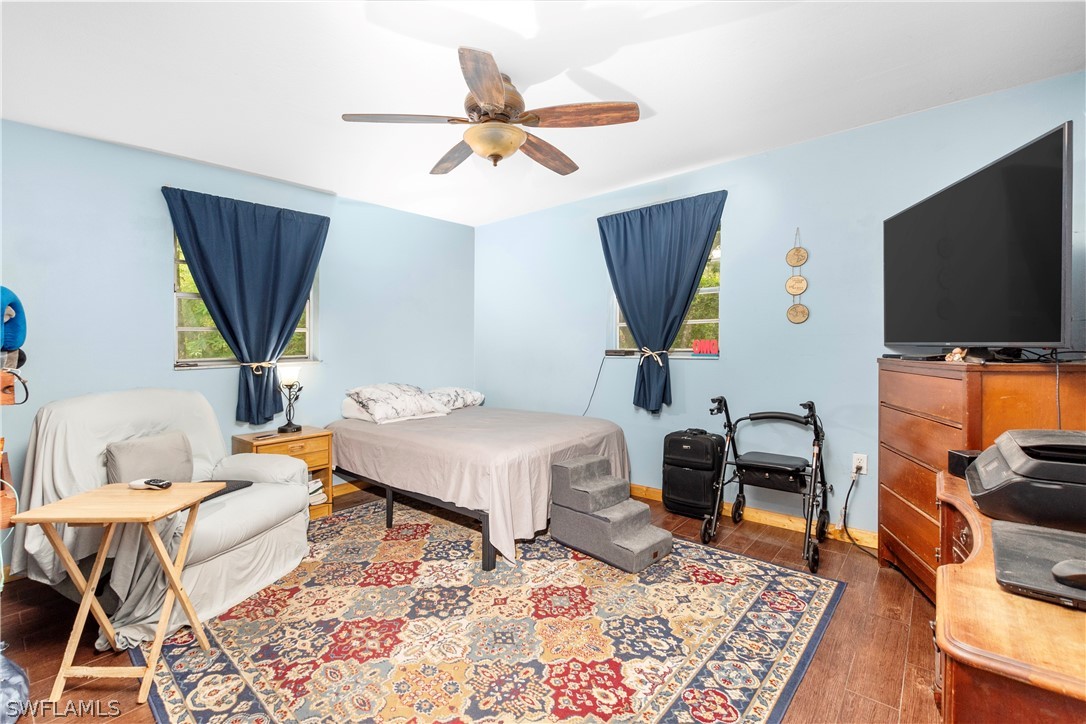 1745 County Road 731 Venus, FL 33960 - Photo 24 of 45 a bedroom with furniture and a flat screen tv