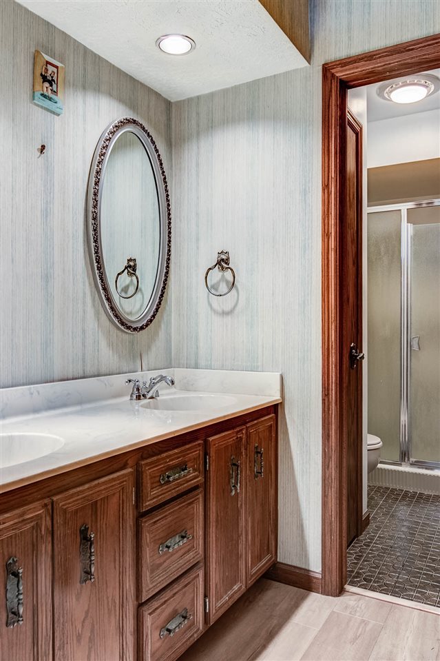 1962 Baintree Road Lake Summerset, IL 61019 - Photo 21 of 25 a bathroom with a granite countertop sink and a mirror