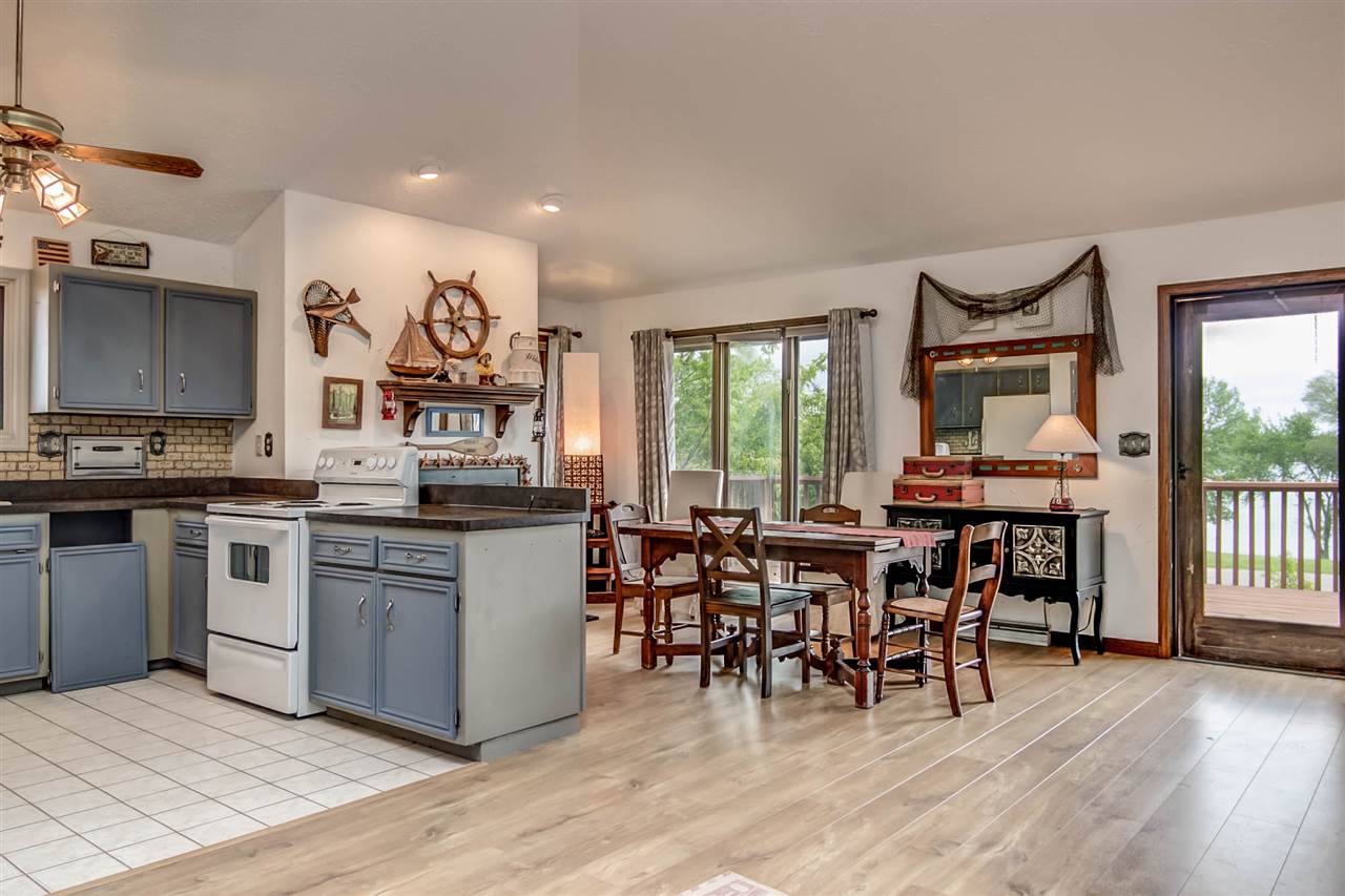 1962 Baintree Road Lake Summerset, IL 61019 - Photo 8 of 25 a kitchen with stainless steel appliances granite countertop a stove top oven a sink a dining table and chairs with wooden floor