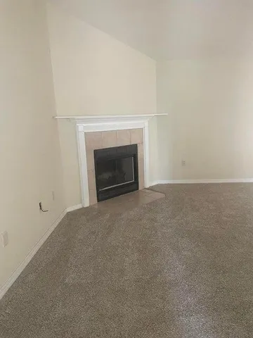 a view of empty room with a fireplace