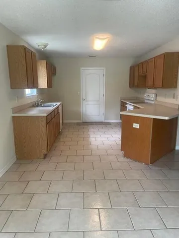 a kitchen with stainless steel appliances granite countertop a sink and a stove