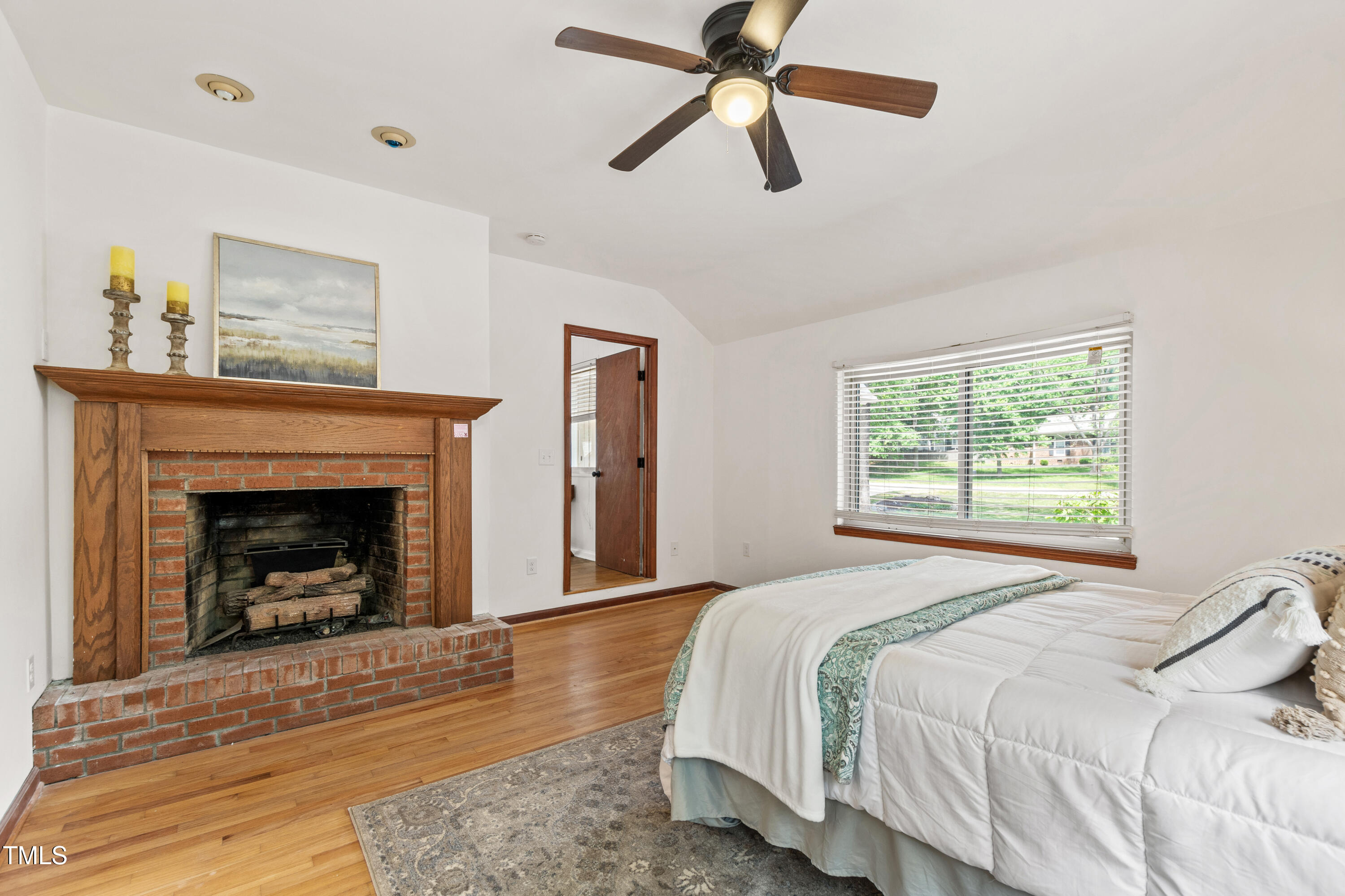 1915 Redding Lane Durham, NC 27712 - Photo 14 of 45 a bedroom with a bed and a fireplace