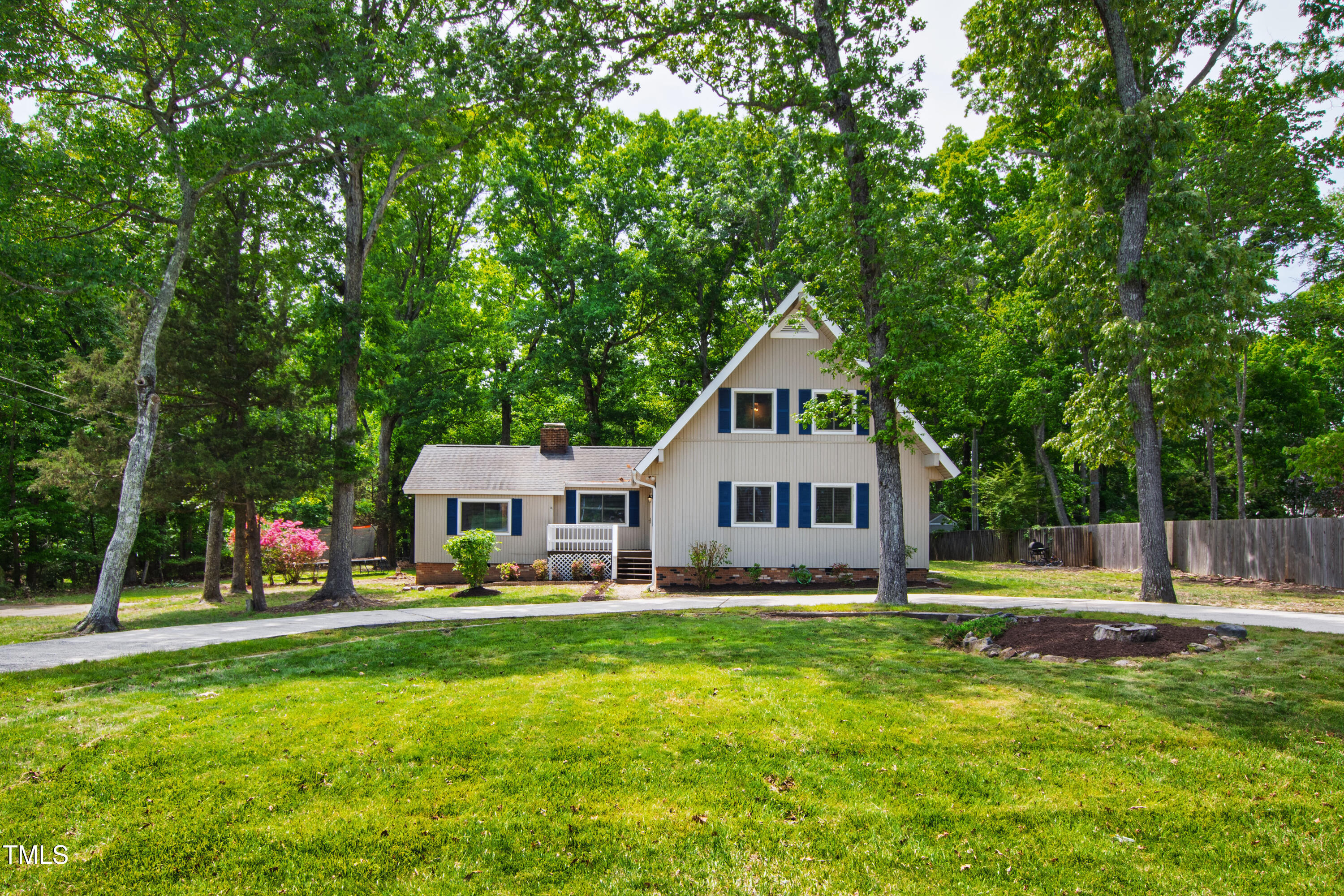 1915 Redding Lane Durham, NC 27712 - Photo 2 of 45 a front view of a house with a yard table and chairs