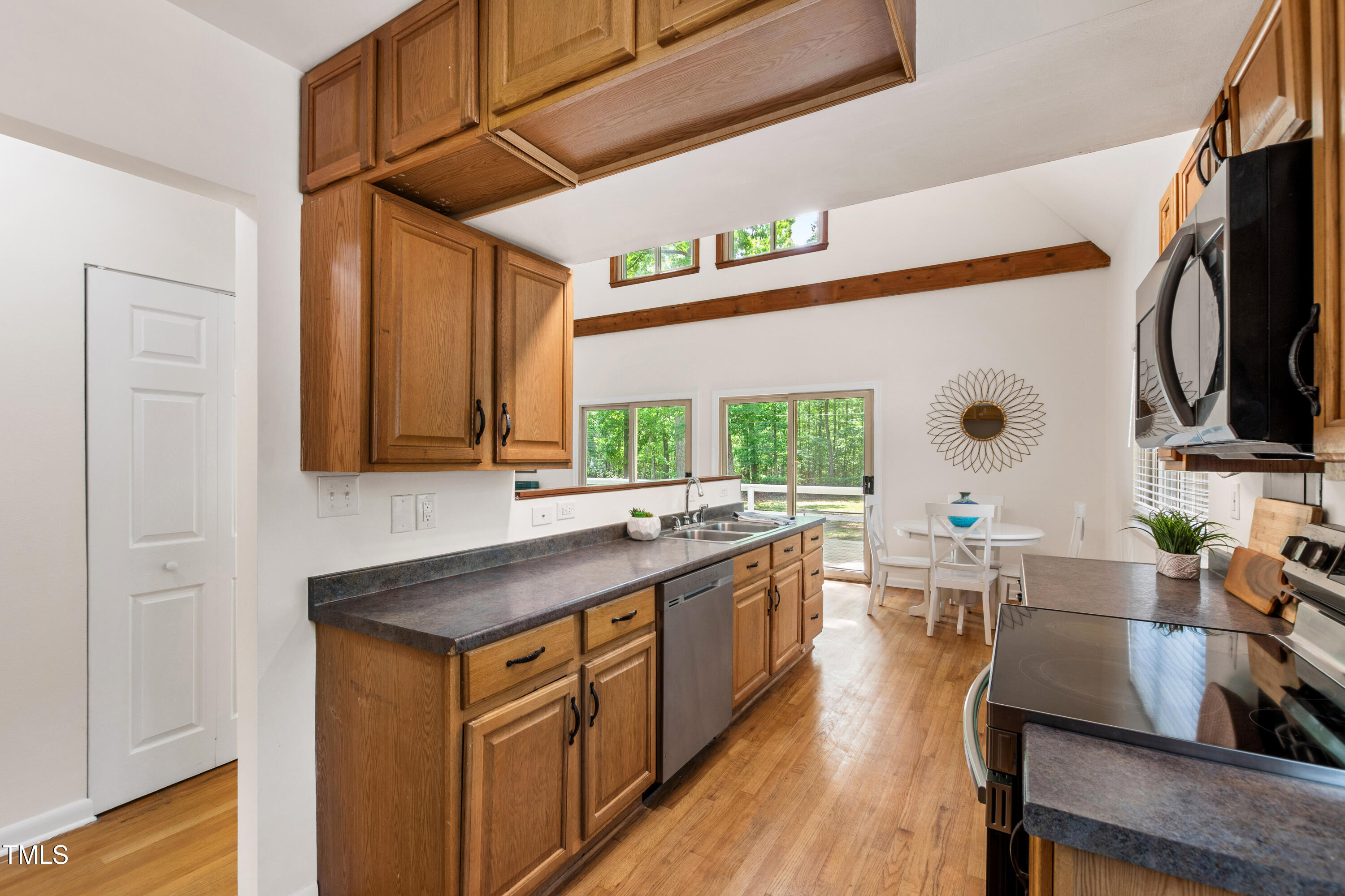 1915 Redding Lane Durham, NC 27712 - Photo 25 of 45 a kitchen with stainless steel appliances granite countertop a sink stove and cabinets