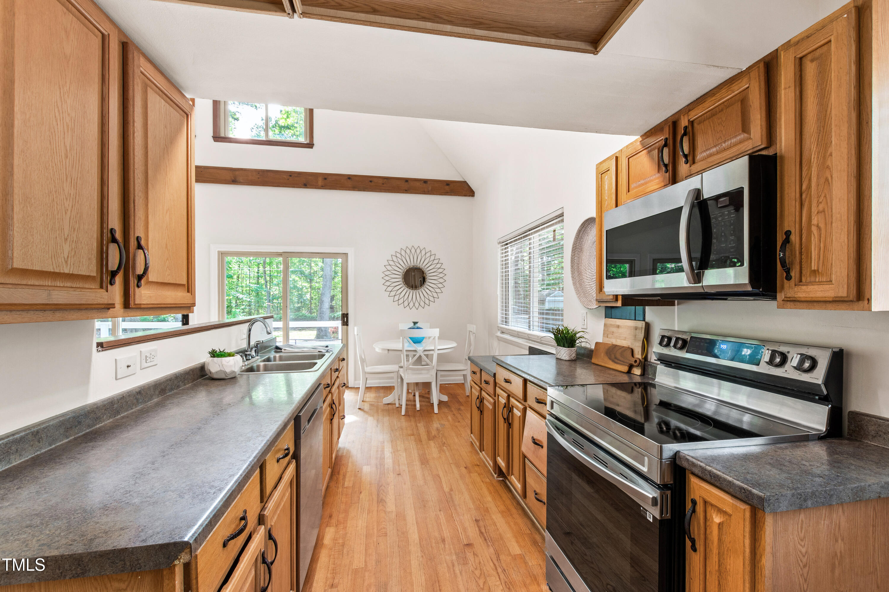 1915 Redding Lane Durham, NC 27712 - Photo 26 of 45 a kitchen with a stove a sink and a microwave