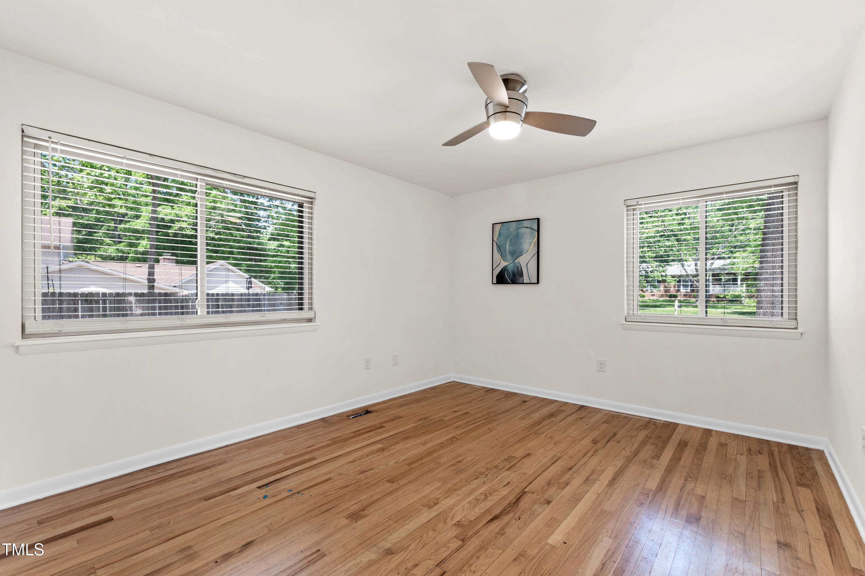 1915 Redding Lane Durham, NC 27712 - Photo 29 of 45 a view of empty room with wooden floor and fan
