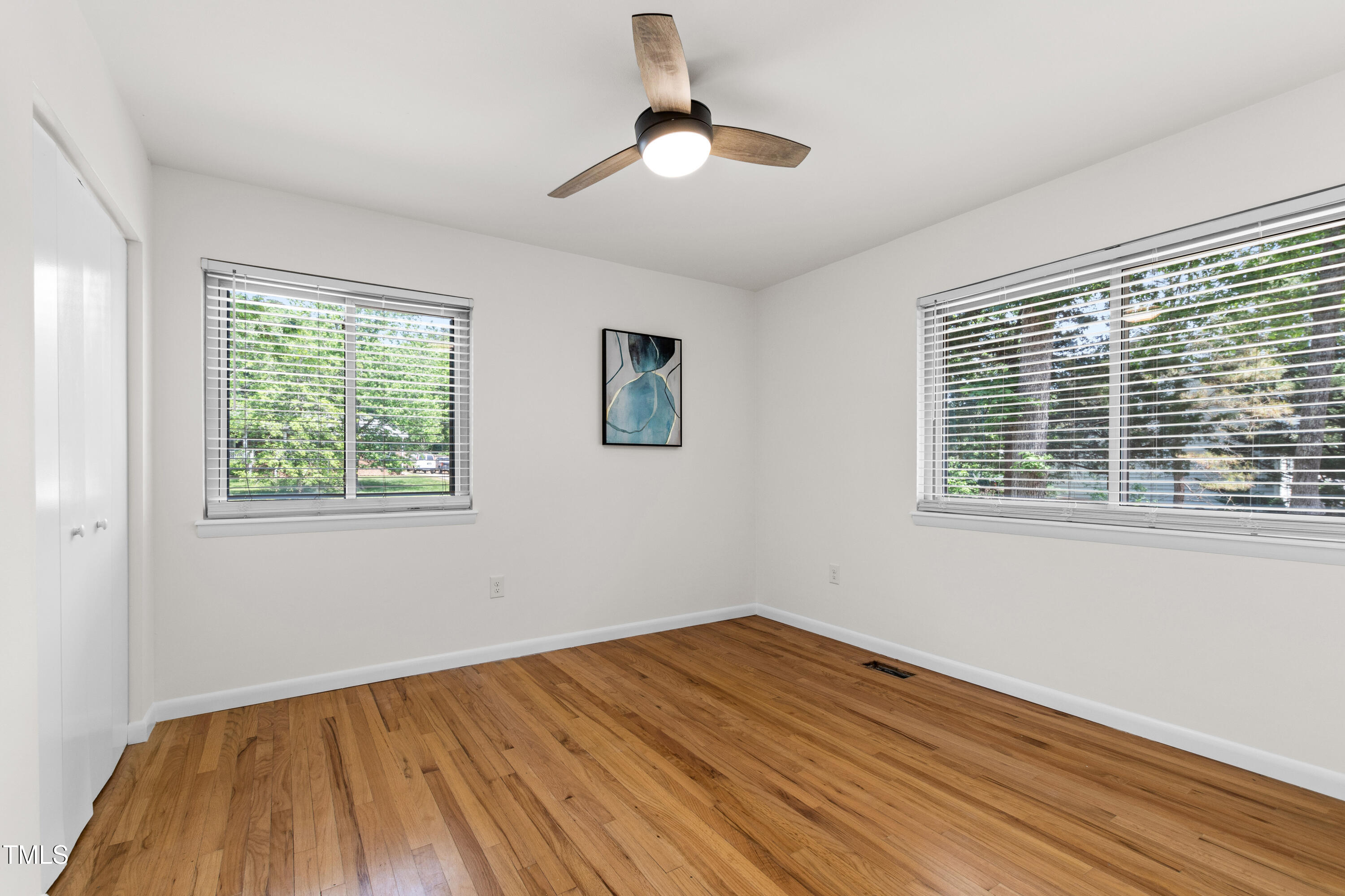 1915 Redding Lane Durham, NC 27712 - Photo 32 of 45 a view of empty room with wooden floor and fan