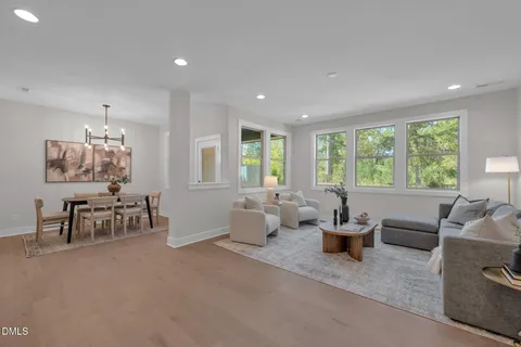 a living room with furniture and large windows