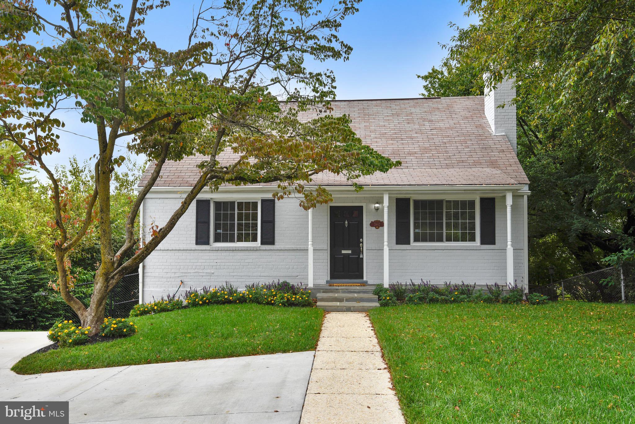 a front view of a house with a garden and yard