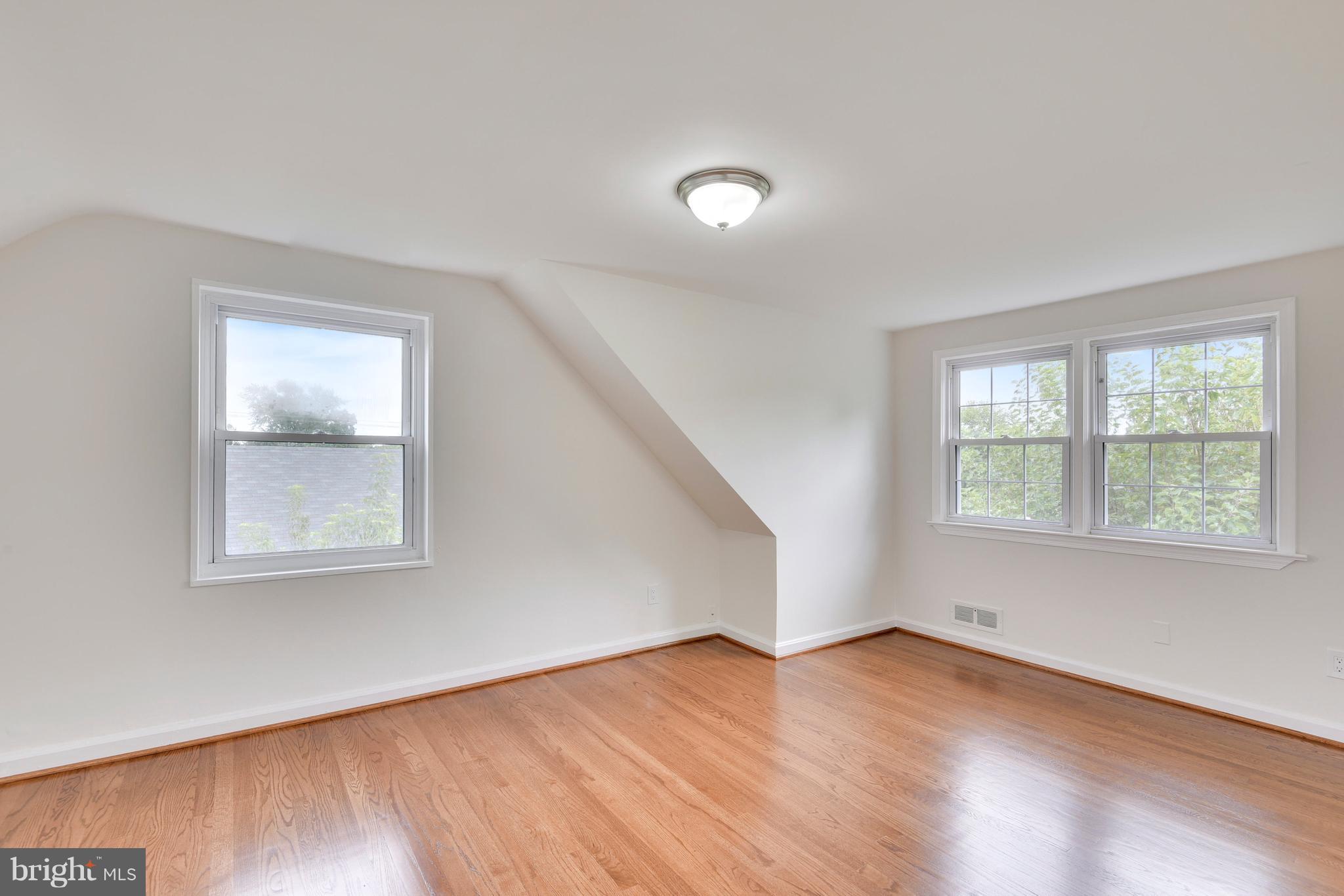 3902 Randolph Road Wheaton, MD 20902 - Photo 16 of 30 an empty room with wooden floor and windows