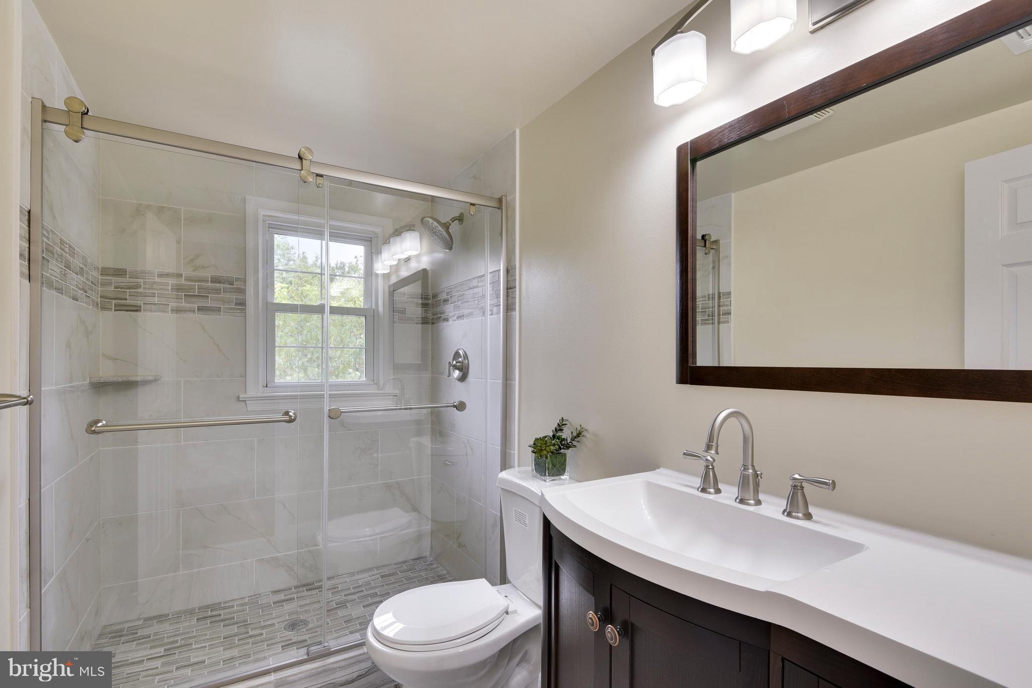 3902 Randolph Road Wheaton, MD 20902 - Photo 18 of 30 a bathroom with a sink toilet a mirror and shower