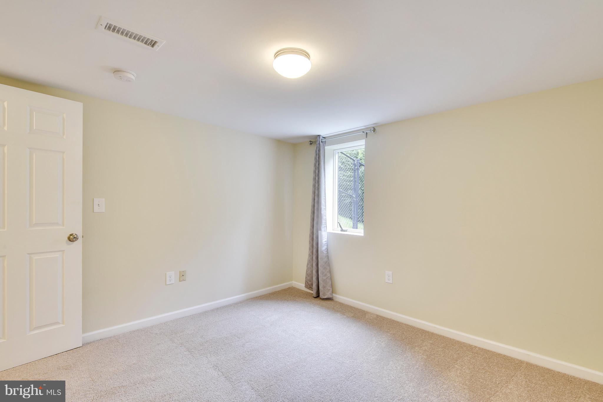 3902 Randolph Road Wheaton, MD 20902 - Photo 23 of 30 an empty room with windows and closet