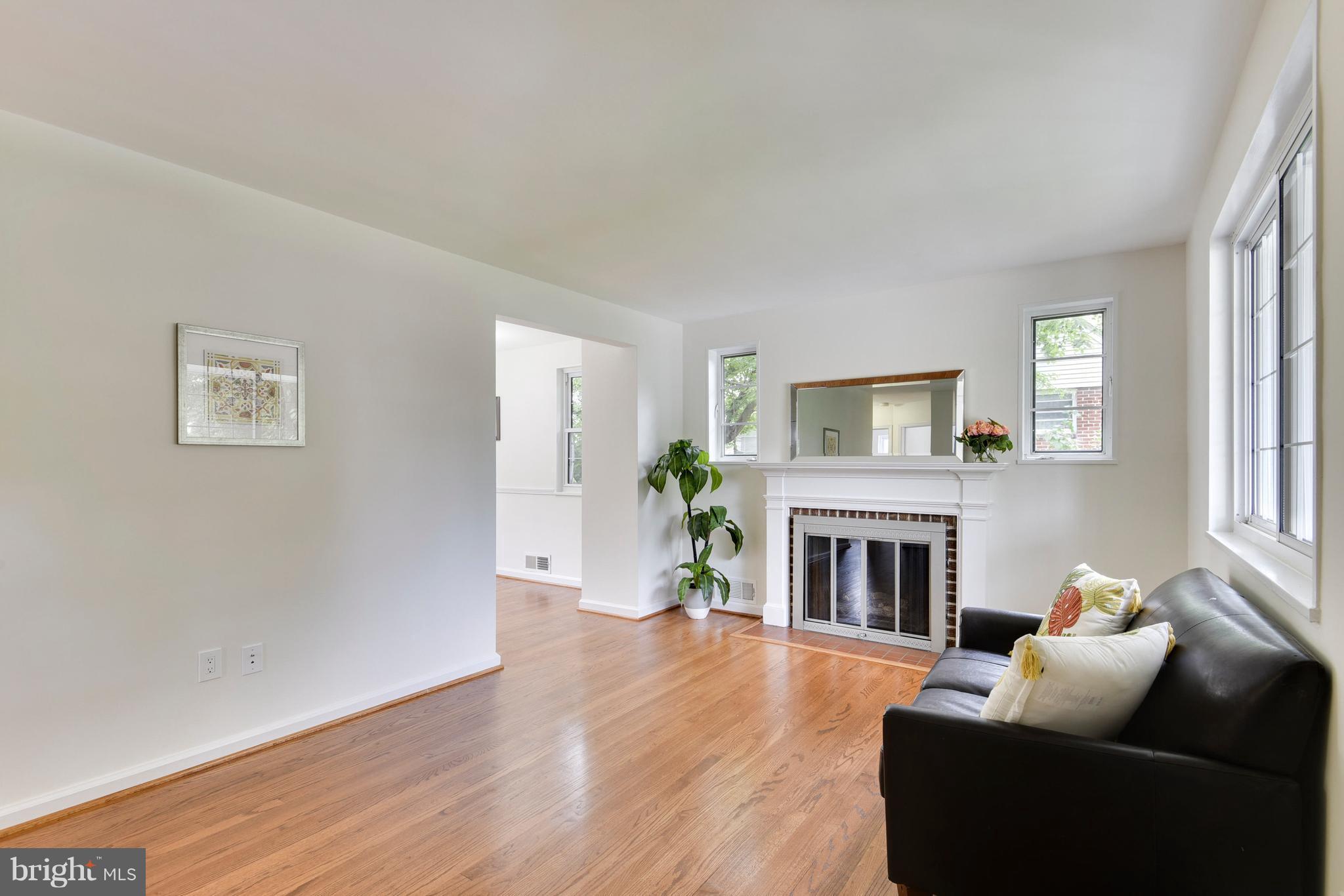 3902 Randolph Road Wheaton, MD 20902 - Photo 4 of 30 a living room with furniture a fireplace and wooden floor
