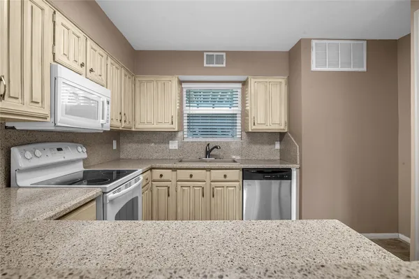 a kitchen with a sink cabinets and window