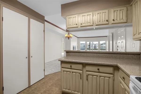 a kitchen with a cabinets and chandelier