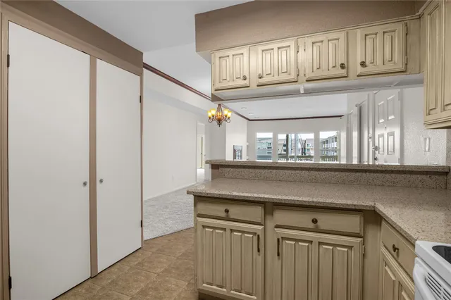 a kitchen with a cabinets and chandelier