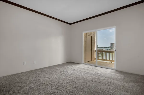 a view of a hallway with wooden floor and a livingroom