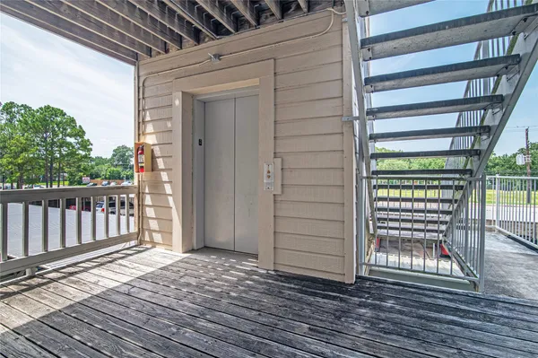 a view of a porch with wooden floor and fence