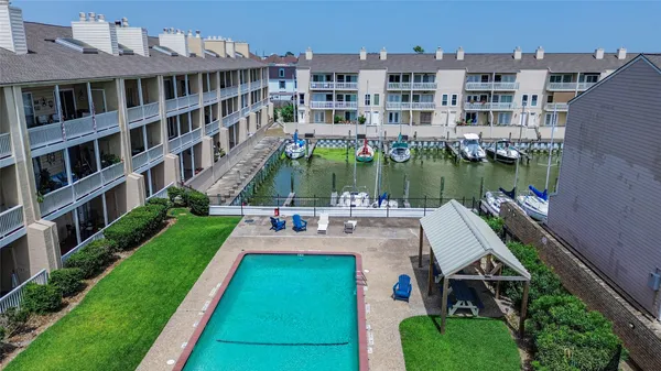 an aerial view of a house with a garden and swimming pool