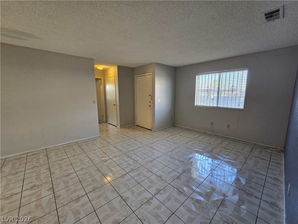 6750 Del Rey Avenue, Unit 133 Las Vegas, NV 89146 - Photo 5 of 34 An inviting living area awaits with durable tile flooring and abundant natural light.