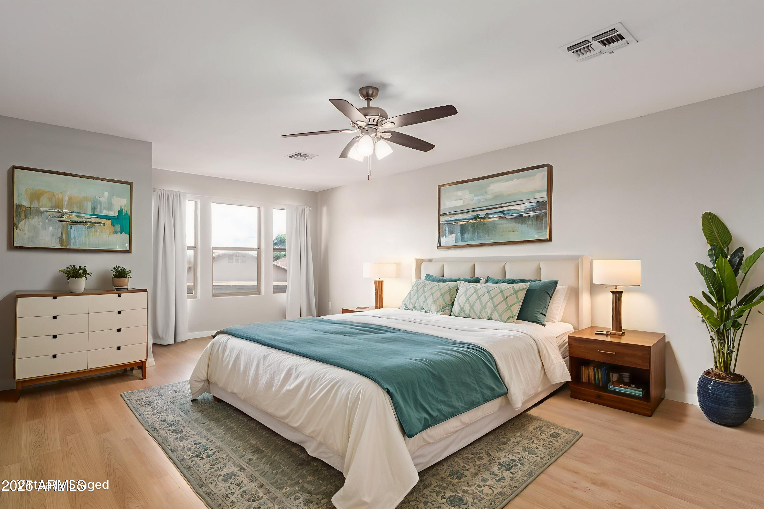 631 South Colonial Court Gilbert, AZ 85296 - Photo 17 of 27 a spacious bedroom with a bed and a chandelier