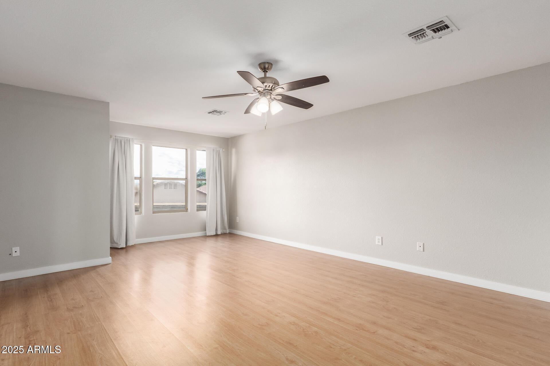 631 South Colonial Court Gilbert, AZ 85296 - Photo 18 of 27 wooden floor in an empty room with a window